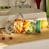 Leak-Resistant Salad Container with Dressing Cup and Side Opening.